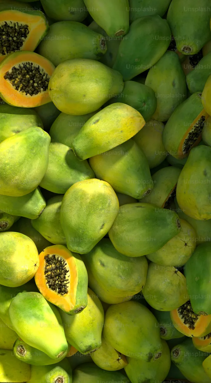 a close up of a bunch of green fruit papaya