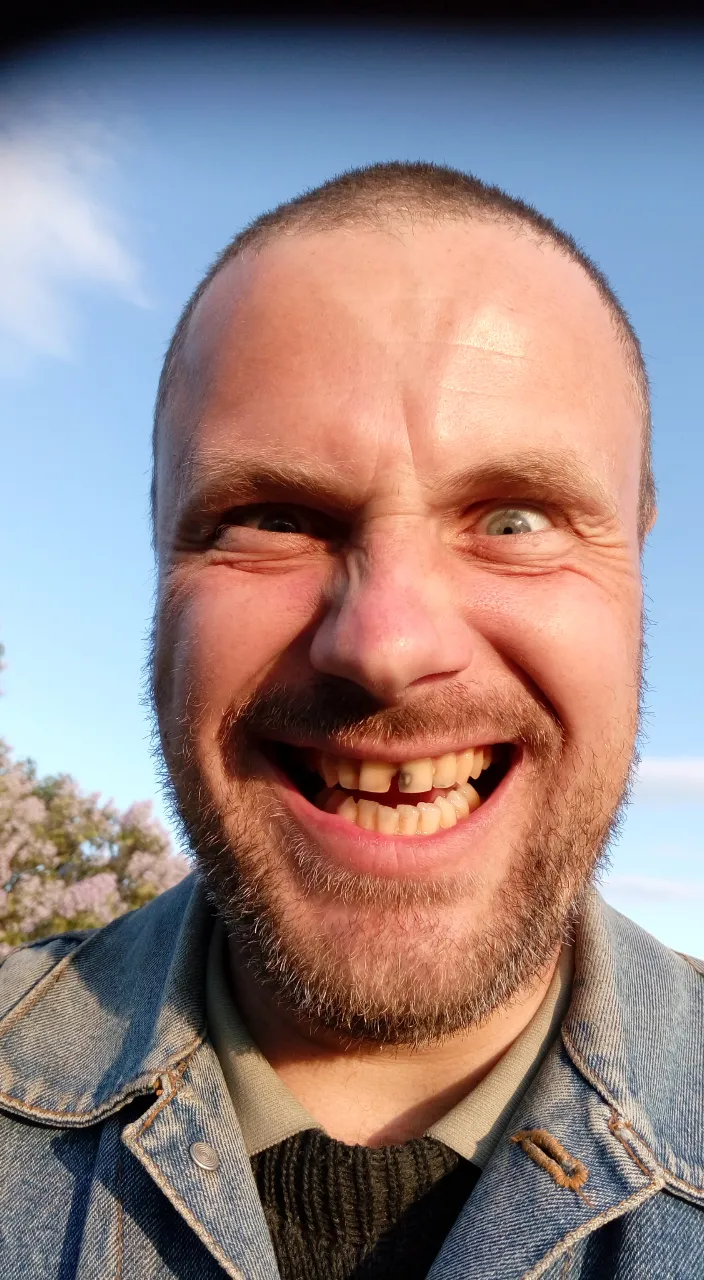 a close up of a person wearing a jean jacket