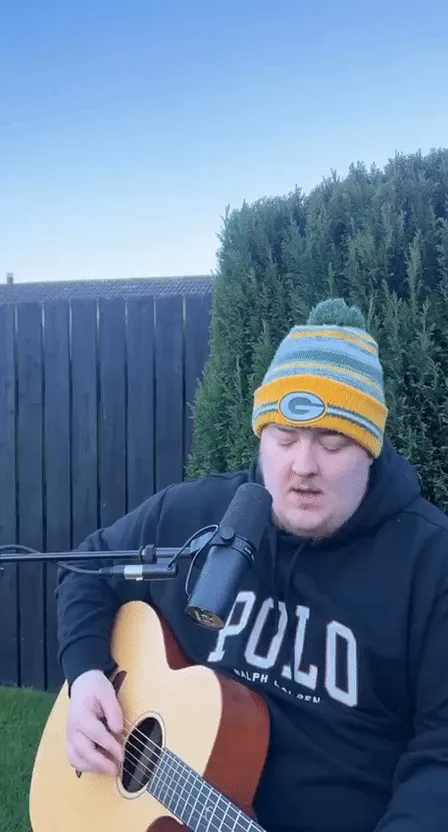 a man sitting in a chair holding a guitar