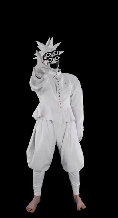 a person in a white outfit with a mask on dancing