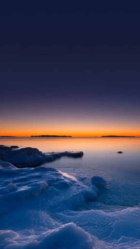 the sun is setting over a body of water