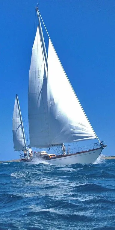 a sailboat is sailing in the open ocean