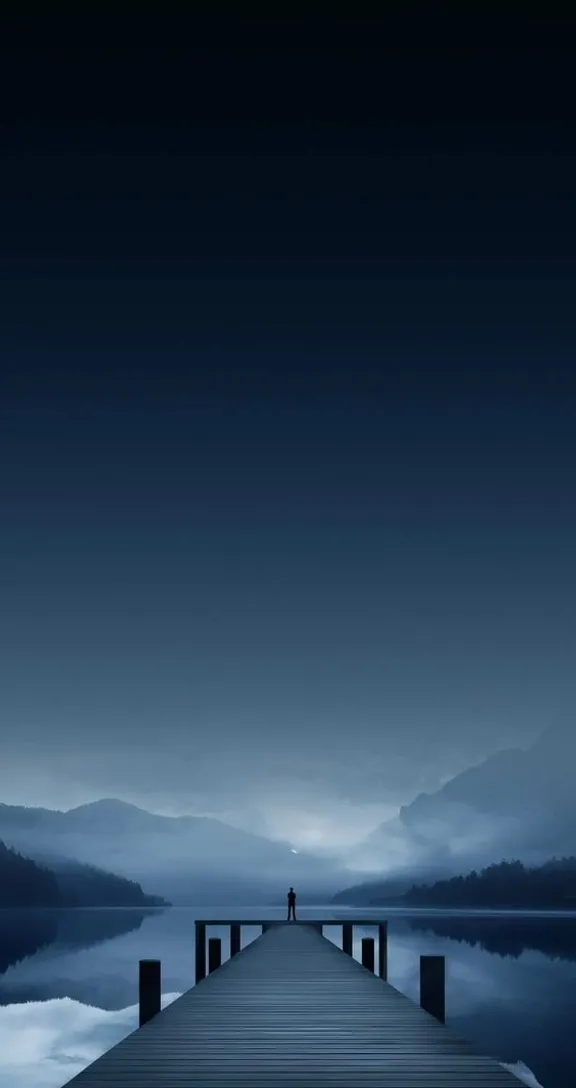 a person standing on a dock at night