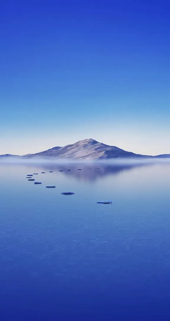 a large body of water with a mountain in the background