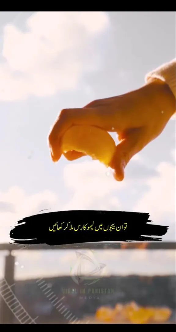 a person holding a piece of lemon in hand pressing lemon to extract lemon jeuice remove the text from the picture