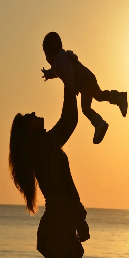 a woman holding a child up in the air