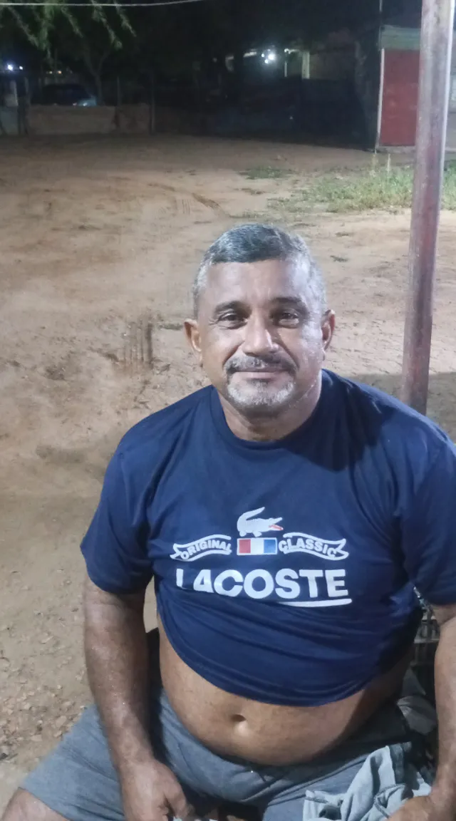 a man in a blue shirt sitting on the ground