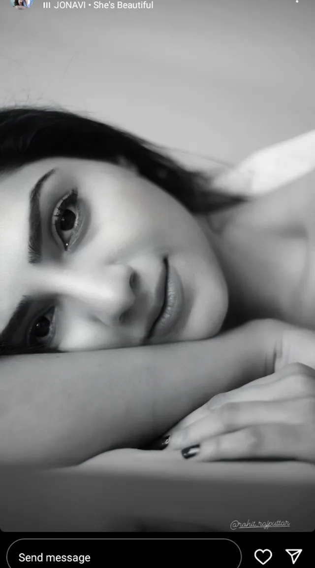 a black and white photo of a woman laying on a bed