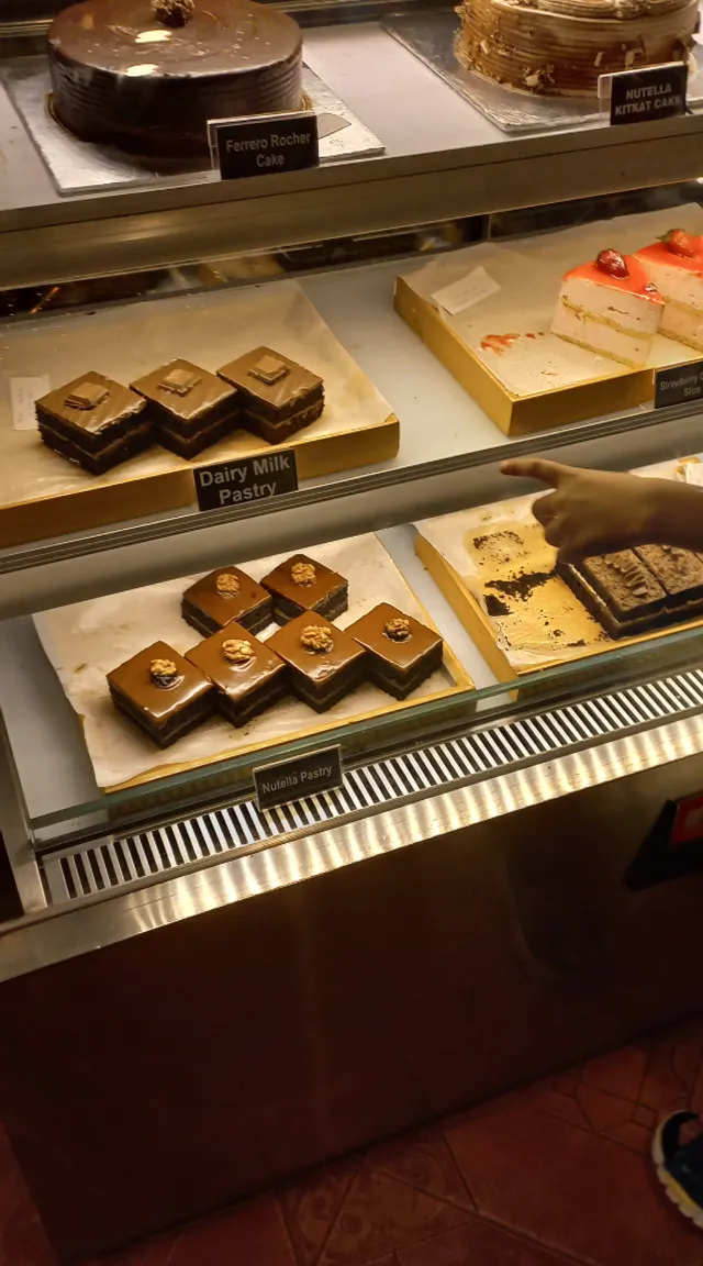 a display case filled with lots of different types of cakes