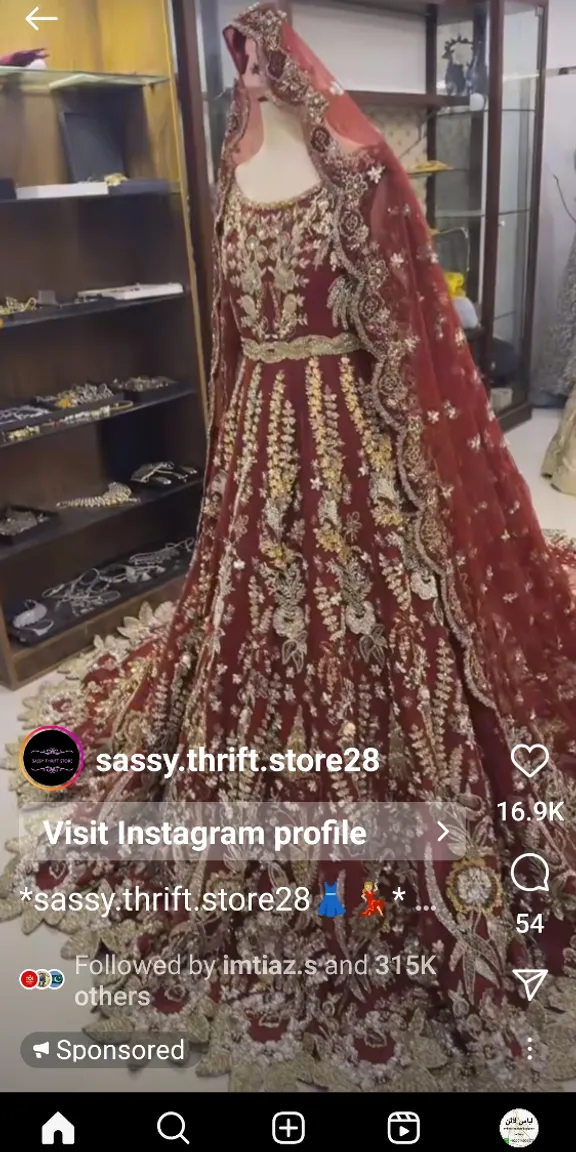 An ethereal window display in a high-end fashion boutique showcasing a delicately embroidered Pakistani wedding dress amid floating clouds and stars