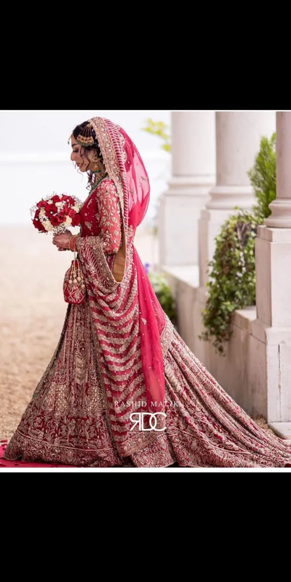 a woman in a red and gold shine material wedding dress 