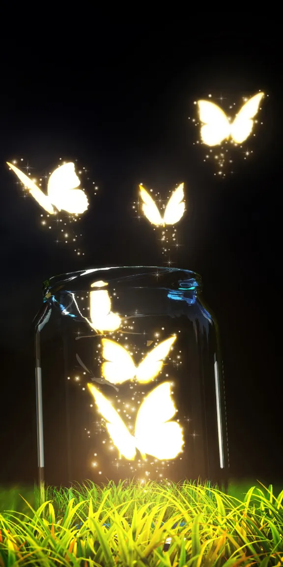 a jar filled with butterflies sitting on top of a lush green field