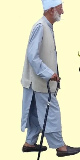 a man walking with a cane and a hat on